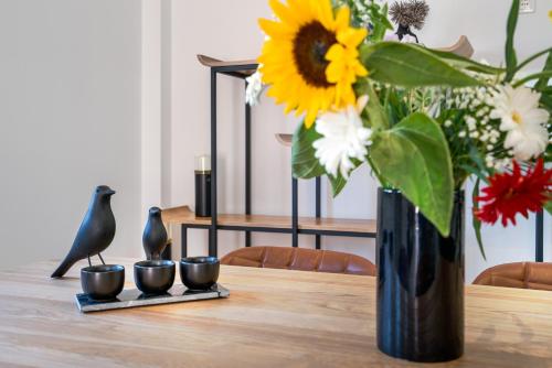 a vase with a sunflower sitting on top of a table at Afroditi Suite in Loutra