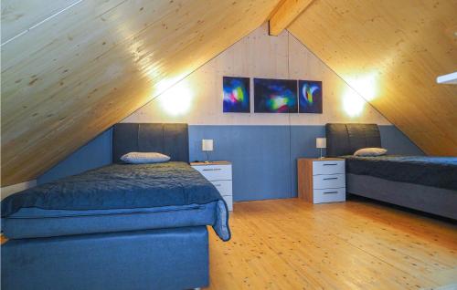 a bedroom with two beds in a attic at Ferienhaus 3 Wolfschlucht in Gondenbrett