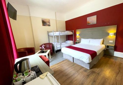 a hotel room with a bed and a bunk bed at Piccadilly Hotel in Bournemouth