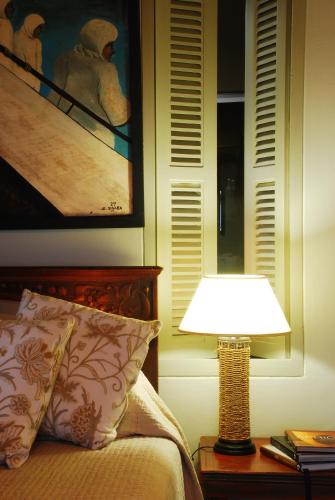 a lamp sitting on a table next to a bed at The Oystercatchers Haven at Paternoster in Paternoster