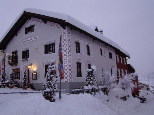 a large white building with snow on it at Crusch Alba in Scuol