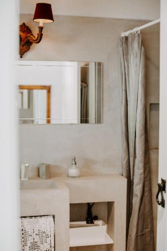 a bathroom with a sink and a mirror at Ponte Pedra Melides -Nature & Ocean- Adults Only in Melides
