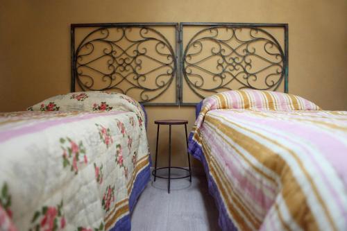 a bedroom with two beds and a table between them at DormidaNoi in Civitanova Marche