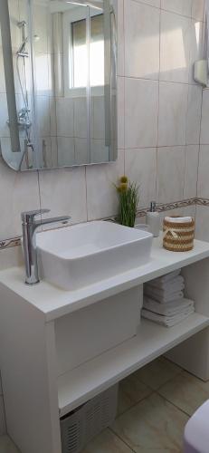 a white bathroom with a sink and a mirror at Happy Dreams Apartment near the beach and old town in Split