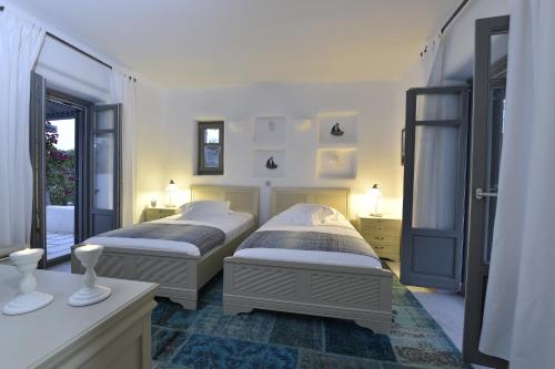 A bed or beds in a room at Naoussa Hills Boutique Resort- Adults Only (13+)