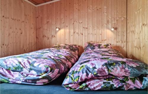 two beds sitting next to each other in a room at 1 Bedroom Amazing Home In Lyngdal in Lyngdal