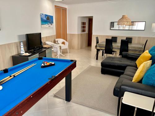 a living room with a pool table and furniture at Arte de Marinheiro in Sesimbra