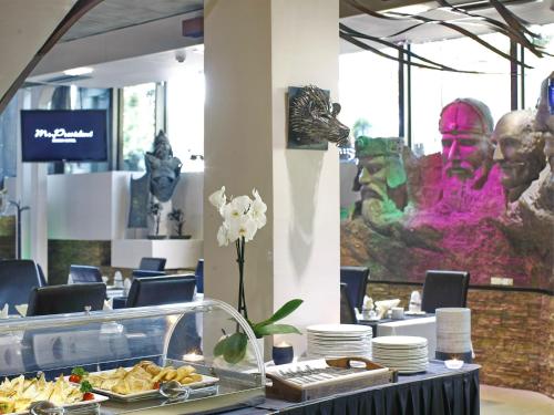 a buffet table with a plate of food on it at Design Hotel Mr President in Belgrade
