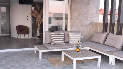 a patio with a couch and a coffee table at Villa Queen in Zadar