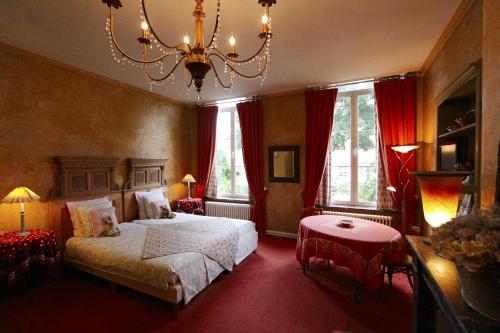 a room with a bed, chair, table and lamps at Home Fleuri Guesthouse in Bruges