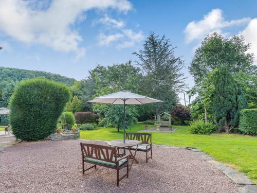 a table and two chairs with an umbrella at Riverside in Craven Arms