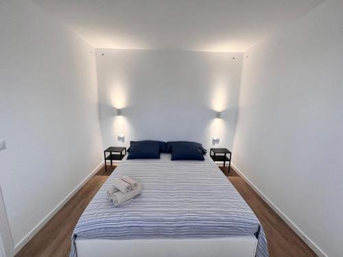a bedroom with a bed with blue pillows on it at Modern Luxury Villa in Poris de Abona