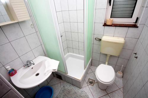 a bathroom with a sink and a toilet and a shower at Apartments with parking space Grebastica, Sibenik - 4867 in Grebaštica
