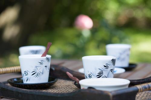 a group of coffee cups sitting on a table at Maison de la Garenne & Spa in Vannes