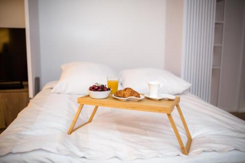 a table with a tray of food on a bed at SMART Apartament BASEN & SPA UNIA ART RESIDENCE Centrum, garaż free,faktura VAT in Lublin