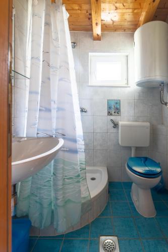 a small bathroom with a toilet and a sink at Apartments by the sea Supetar, Brac - 6075 in Supetar