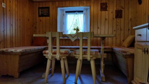 una habitación con 2 sillas y una mesa en una cabaña en Počitniška hiša Ukanc, en Bohinj