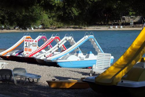 a group of slides and chairs next to the water at Apartments with a parking space Supetar, Brac - 5676 in Supetar