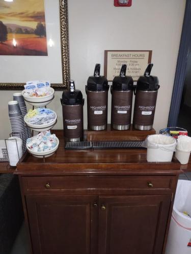 a table with three bottles of soap and plates on it at Country Inn & Suites by Radisson, Buford at Mall of Georgia, GA in Buford