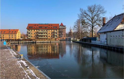 a river in a city with buildings in the background at Cozy Ship In Neuruppin With House Sea View in Neuruppin