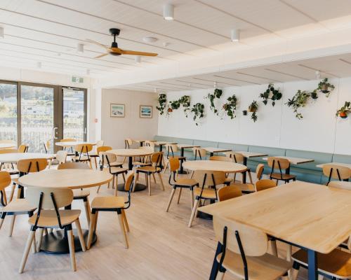 a classroom with tables and chairs and a ceiling at Driftaway Queenstown in Queenstown