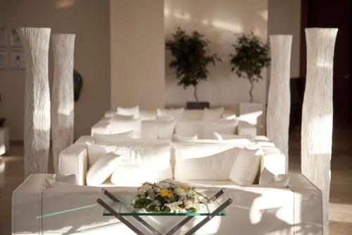 a white couch with a glass table in a room at Port Royal Villas and Spa - Adults Only in Kolimbia