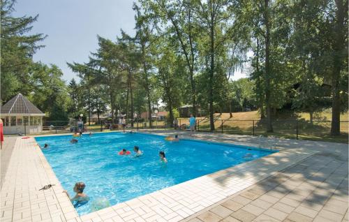a group of people swimming in a swimming pool at Stunning Home In Heel With Lake View in Heel