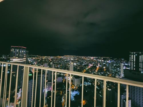 a view of the city at night from the top of a building at PANORAMA Condotel by HLG in Nha Trang