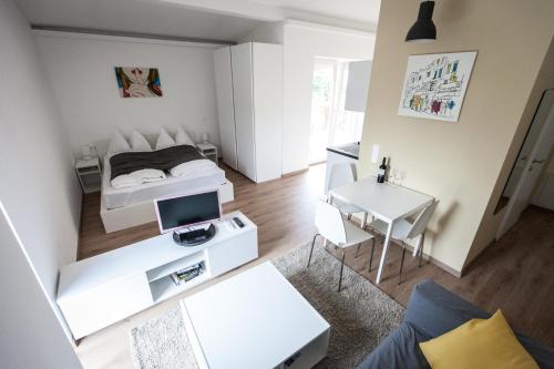 a small apartment with a bed and a desk at Studios + in Graz