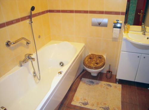 a bathroom with a tub and a toilet and a sink at Family friendly house with a swimming pool Jezera, Murter - 5124 in Jezera