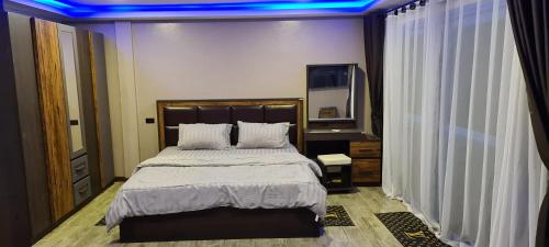a bedroom with a large bed with blue lights on it at Central Guesthouse Chiang Rai - Bread & Breakfast in Chiang Rai