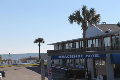 a beachside motel with palm trees in front of it at Beachside Motel - Amelia Island in Amelia Island
