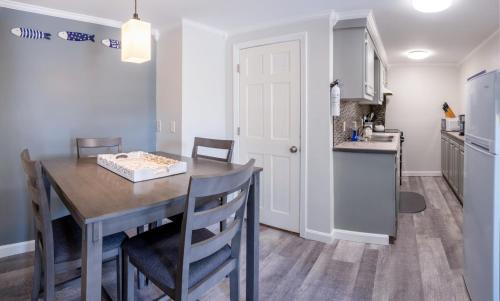 a kitchen and dining room with a table and chairs at Main Street Downtown Apartments in Bar Harbor