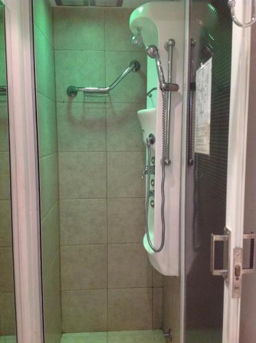 a shower with a glass door in a bathroom at Olas Apart High Comfort in Villa Gesell