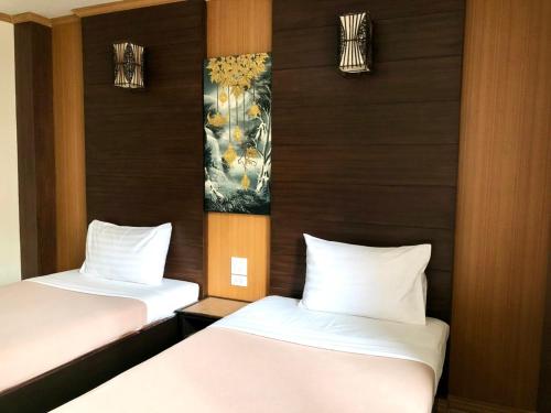 Postel nebo postele na pokoji v ubytování Visanuinn Hotel