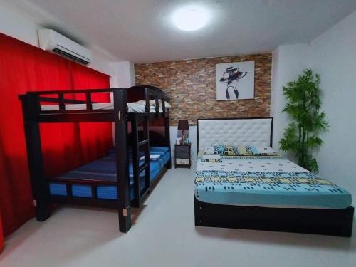 a bedroom with two bunk beds and a bed at N&J Lopez Lodging House in Manila