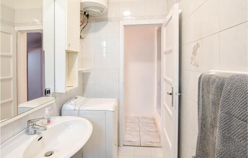 a white bathroom with a sink and a toilet at Nice Apartment In Avio With Wifi in Avio