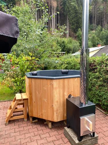 a wooden bath tub sitting next to a stove at Molltaler Appartements en b&b in Stall