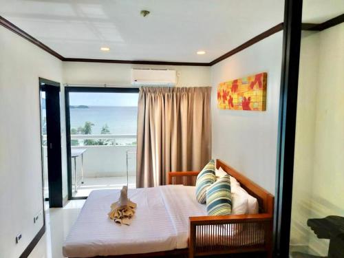 a bedroom with a bed with a view of the ocean at Patong Tower Amazing Sea View 12 by PHR in Patong Beach