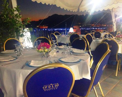 a table set up for a wedding with tables and chairs at Hotel Centro Congressi Polo Nautico in Salerno