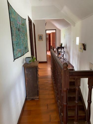 a hallway with a wooden staircase in a house at Villa Bougainvillea piscine et proche lagon in La Saline les Bains