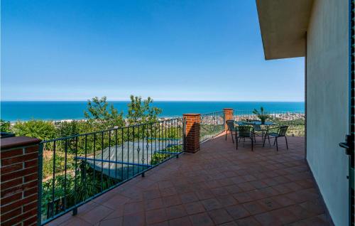 a balcony with a table and chairs and the ocean at Nice Home In Belsito With Wifi in Montepagano