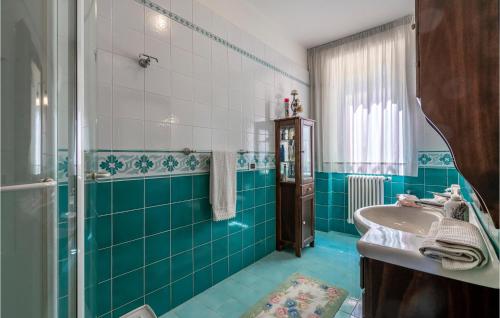a blue bathroom with a sink and a shower at Nice Home In Belsito With Wifi in Montepagano
