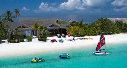 two boats in the water in front of a beach at Cora Cora Maldives - Premium All-Inclusive Resort in Raa Atoll