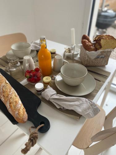 une table recouverte d'une table avec du pain et un couteau dans l'établissement Casa louisa chambre sauna et bain nordique, à Wailly-Beaucamp