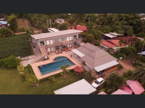 an aerial view of a house with a swimming pool at Pakham Gardens Resort in Prakham
