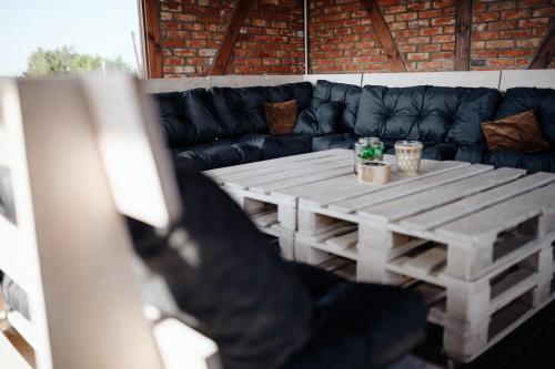 a living room with a table and a couch at Folwark Pod Dębem in Nowa Karczma