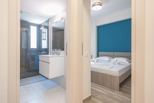 a bedroom with a bed and a sink and a mirror at Newly renovated apt in the heart of Kerameikos in Athens