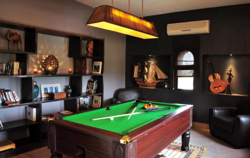 a billiard room with a pool table in it at Riad Al Mendili Private Resort & Spa in Had Abdallah Rhiat
