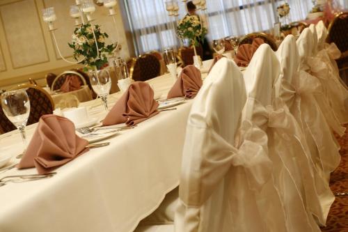 a row of tables with white table cloths on them at Ramada by Wyndham St. John's in St. John's